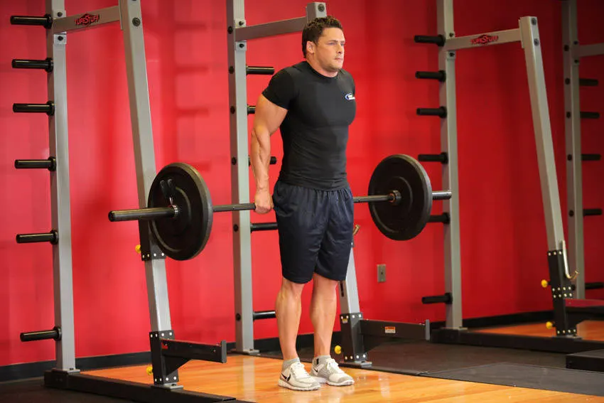 Barbell Shrug Behind The Back — end position