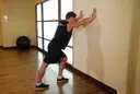 Calf Stretch Hands Against Wall exercise
