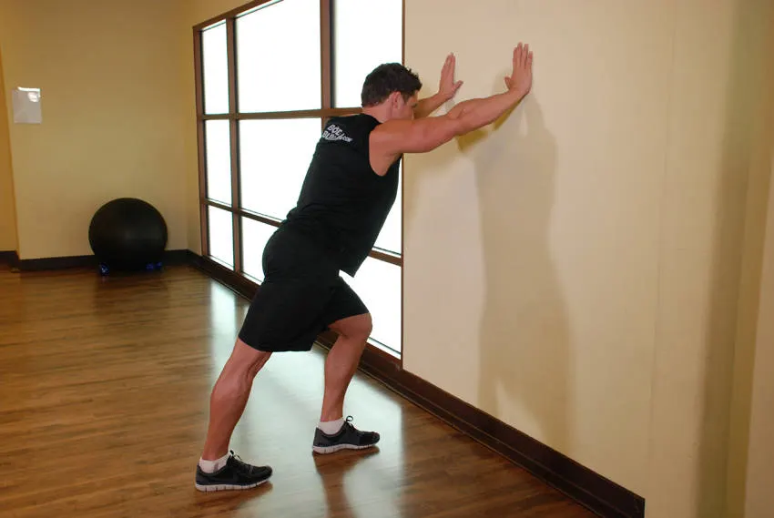 Calf Stretch Hands Against Wall exercise