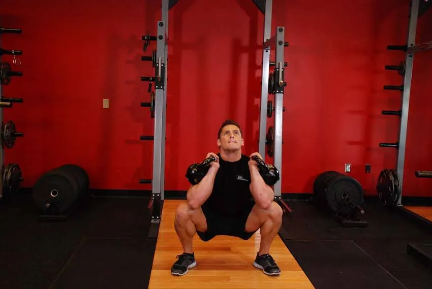 Front Squats With Two Kettlebells — end position