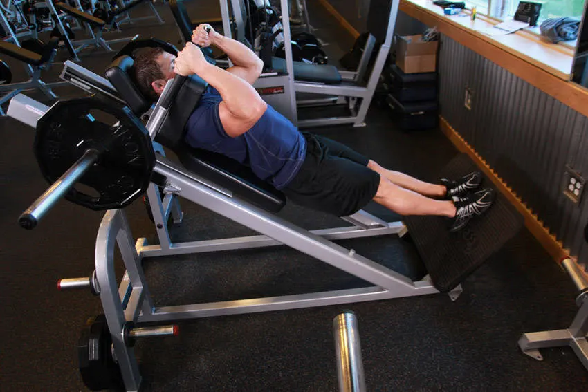 Narrow Stance Hack Squats — end position