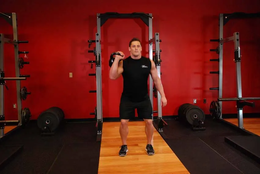 One-Arm Kettlebell Split Jerk — end position