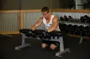 Palms-Down Dumbbell Wrist Curl Over A Bench exercise
