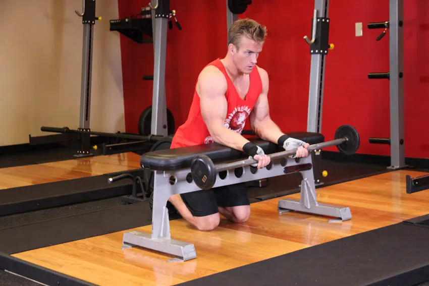 Palms-Up Barbell Wrist Curl Over A Bench exercise