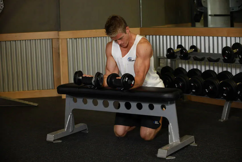 Palms-Up Dumbbell Wrist Curl Over A Bench — end position