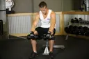 Seated Dumbbell Palms-Down Wrist Curl exercise