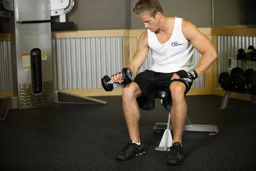 Seated One-Arm Dumbbell Palms-Down Wrist Curl — end position