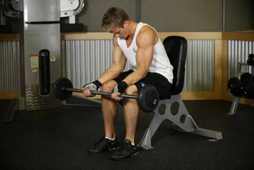 Seated Palm-Up Barbell Wrist Curl exercise