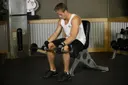 Seated Palms-Down Barbell Wrist Curl exercise
