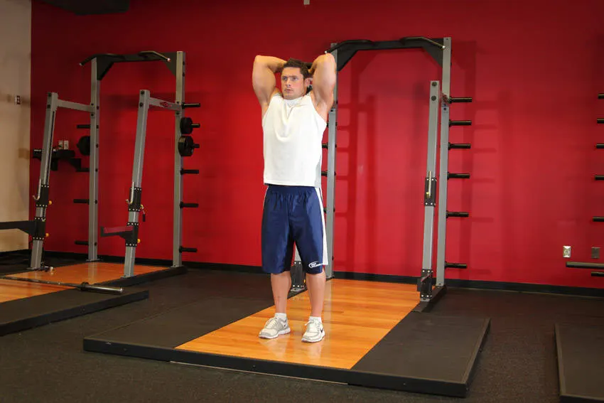 Standing Dumbbell Triceps Extension — end position