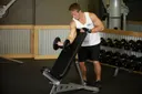 Standing One-Arm Dumbbell Curl Over Incline Bench exercise