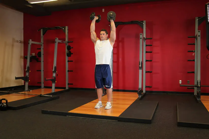 Standing Palms-In Dumbbell Press — starting position