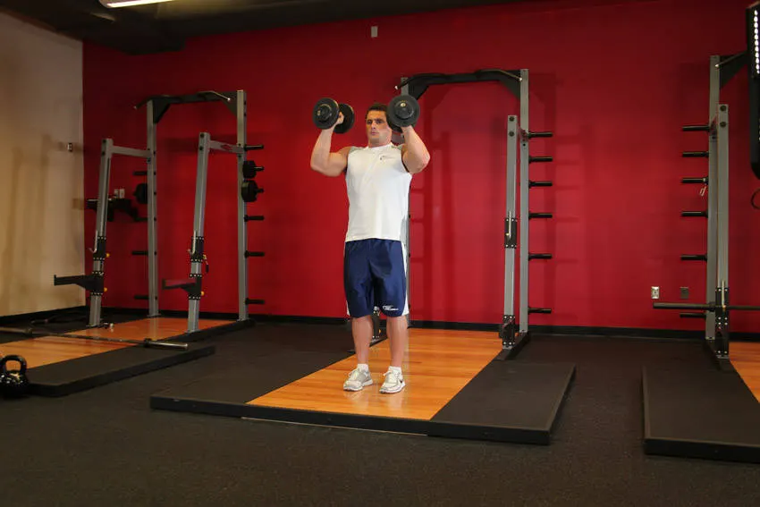 Standing Palms-In Dumbbell Press — end position