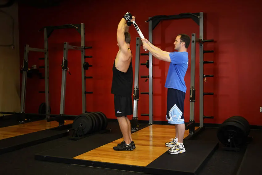 Standing Towel Triceps Extension — end position